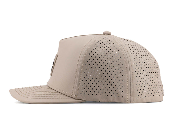 Boulder colored Rover premium performance fitted hat from Hatchet Headwear pictured with a white foreground and background. The hat is positioned at an approximately 90 degree angle to showcase the left-side profile of the hat. The diamond shaped laser perforations of the hat designed to provide breathability and reduce heat retention are prominently featured.