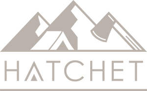 Light taupe company logo for Hatchet Headwear with a stylized hatchet, tent, and mountain design.