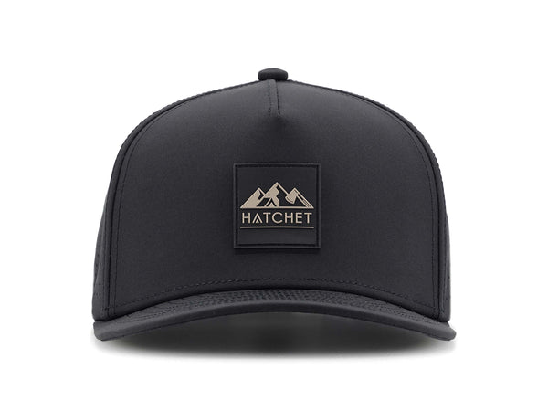 Black colored Rover premium performance fitted hat from Hatchet Headwear pictured with a white foreground and background.  Hat features a color matched Black rubber logo patch with the Hatchet Headwear logo (mountains, tent, and  hatchet above the word "HATCHET) in taupe.  The hat is pictured from the front and facing directly at the camera.