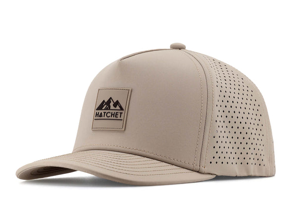 Boulder colored Rover premium performance fitted hat from Hatchet Headwear pictured with a white foreground and background.  Hat features a color matched Boulder rubber logo patch with the Hatchet Headwear logo (mountains, tent, and  hatchet above the word "HATCHET) in black.  The hat is positioned at an approximately 45 degree angle to showcase the front and left-side profile of the hat.