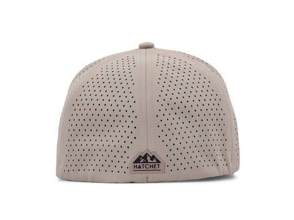 Boulder colored Rover premium performance fitted hat from Hatchet Headwear pictured with a white foreground and background.  Hat features a color matched Boulder rear rubber logo patch with the Hatchet Headwear logo (mountains, tent, and  hatchet above the word "HATCHET) in black.  The hat is photographed from the rear to depict the fitted nature of the hat and stylish Hatchet Headwear logo on the back of the hat.  Also prominently featured are the diamond shaped laser perforations for breathability.