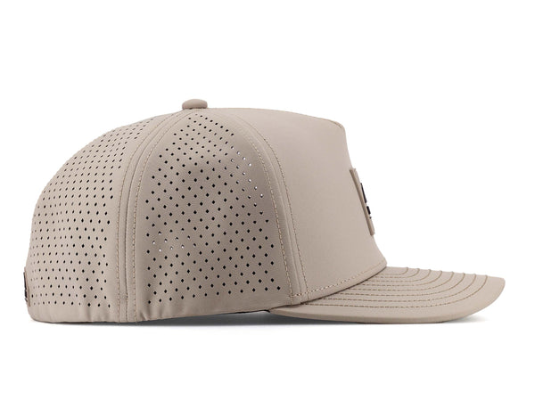 Boulder colored Rover premium performance fitted hat from Hatchet Headwear pictured with a white foreground and background.  The hat is positioned at an approximately 90 degree angle to showcase the right-side profile of the hat.  The diamond shaped laser perforations of the hat designed to provide breathability and reduce heat retention are prominently featured.