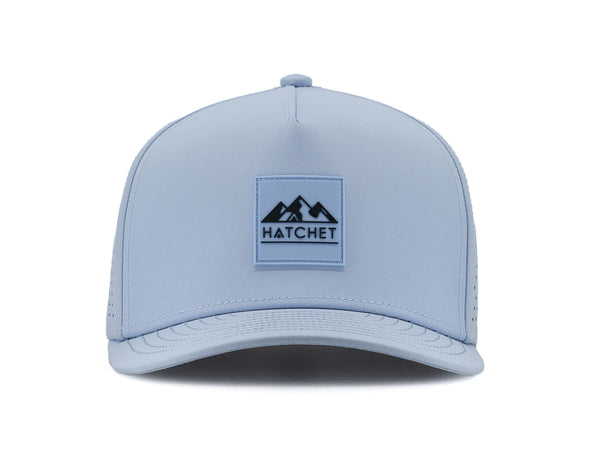 Glacier colored Rover premium performance fitted hat from Hatchet Headwear pictured with a white foreground and background.  Hat features a color matched Glacier rubber logo patch with the Hatchet Headwear logo (mountains, tent, and  hatchet above the word "HATCHET) in slate blue.  The hat is pictured from the front and facing directly at the camera.