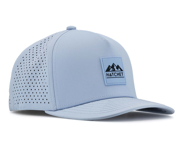 Glacier colored Rover premium performance fitted hat from Hatchet Headwear pictured with a white foreground and background.  Hat features a color matched Glacier rubber logo patch with the Hatchet Headwear logo (mountains, tent, and  hatchet above the word "HATCHET) in slate blue.  The hat is positioned at an approximately 45 degree angle to showcase the front and right-side profile of the hat.