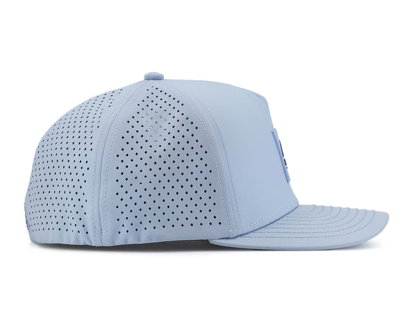 Glacier colored Rover premium performance fitted hat from Hatchet Headwear pictured with a white foreground and background.  The hat is positioned at an approximately 90 degree angle to showcase the right-side profile of the hat.  The diamond shaped laser perforations of the hat designed to provide breathability and reduce heat retention are prominently featured.
