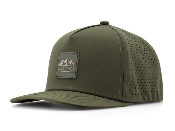 Hunter Green colored Rover premium performance fitted hat from Hatchet Headwear pictured with a white foreground and background.  Hat features a color matched Hunter Green rubber logo patch with the Hatchet Headwear logo (mountains, tent, and  hatchet above the word "HATCHET) in taupe.  The hat is positioned at an approximately 45 degree angle to showcase the front and left-side profile of the hat.