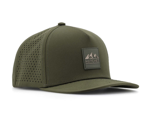 Hunter Green colored Rover premium performance fitted hat from Hatchet Headwear pictured with a white foreground and background.  Hat features a color matched Hunter Green rubber logo patch with the Hatchet Headwear logo (mountains, tent, and  hatchet above the word "HATCHET) in taupe.  The hat is positioned at an approximately 45 degree angle to showcase the front and right-side profile of the hat.