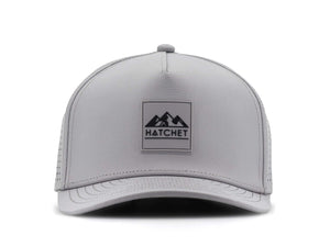 Smoke colored Rover premium performance fitted hat from Hatchet Headwear pictured with a white foreground and background.  Hat features a color matched Smoke rubber logo patch with the Hatchet Headwear logo (mountains, tent, and  hatchet above the word "HATCHET) in black.  The hat is pictured from the front and facing directly at the camera.